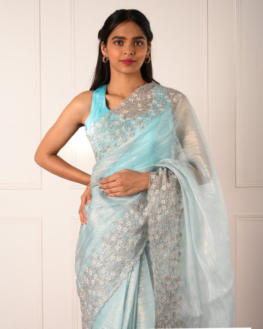 Nuraani – Blue Tissue Saree with Floral Thread Embroidery & Sequin Accents