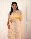 Nuraani – Golden Tissue Saree with Floral Thread Embroidery & Sequin Accents