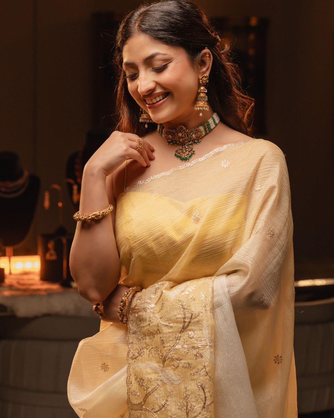 Woman in a yellow saree with a blurred background