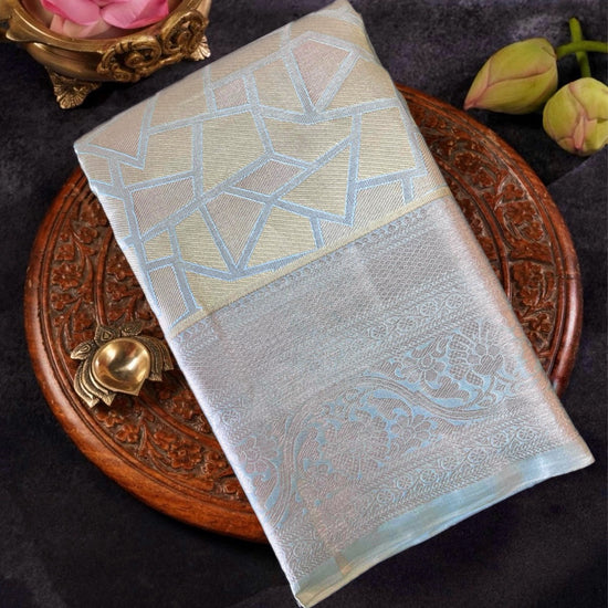 Decorative fabric with geometric pattern on a wooden plate with flowers and a rose.